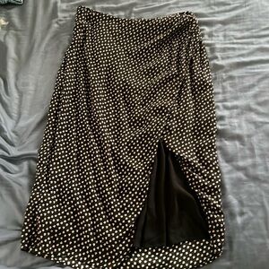 Long black skirt with pink and white flowers, has a slit as well, zips up